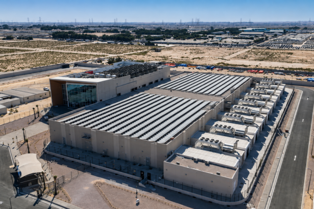 A large data center complex in the Gulf surrounded by desert infrastructure and power transmission lines
