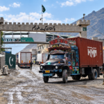 Pakistan-Afghanistan border crossing at Torkham with cargo trucks and security personnel