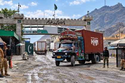 Pakistan-Afghanistan border crossing at Torkham with cargo trucks and security personnel