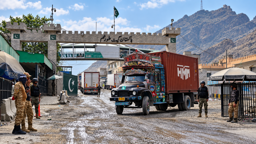 Pakistan-Afghanistan border crossing at Torkham with cargo trucks and security personnel