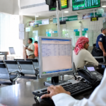 Saudi bank branch with customers and employees using digital banking systems