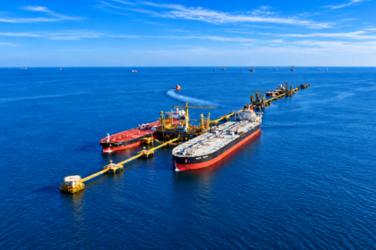 Two oil tankers moored at an offshore loading terminal in the Red Sea, with pipelines and marine infrastructure extending into the distance.