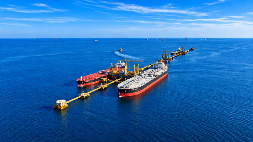 Two oil tankers moored at an offshore loading terminal in the Red Sea, with pipelines and marine infrastructure extending into the distance.